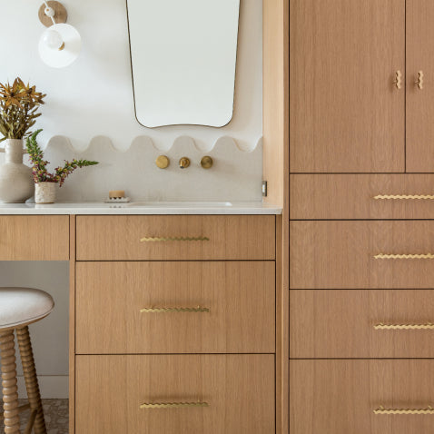 Oak bathroom vanity with brass squiggle pulls