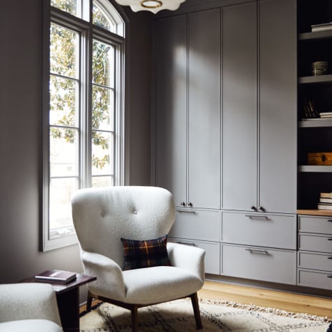 Grey living room with boucle chair and antique brass hardware